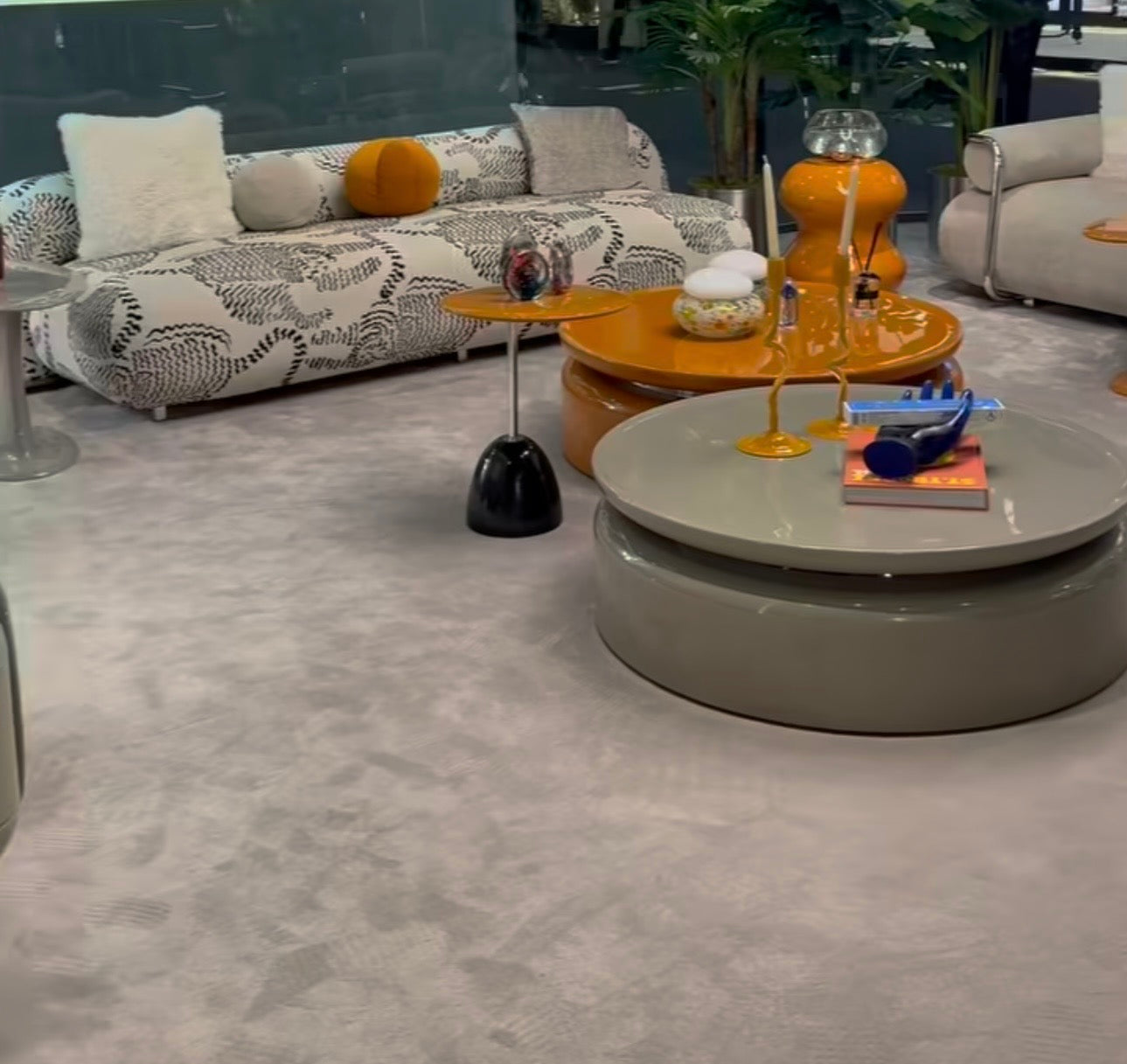 Lowlight modern lacquer furniture collection with sculptural orange sideboard, statement coffee tables, and contemporary dining design.