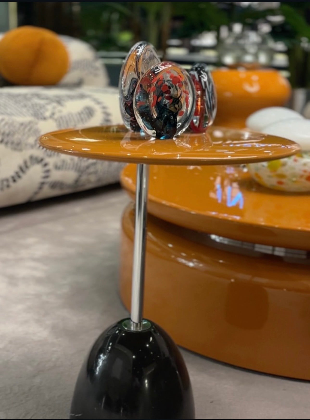 Lowlight modern lacquer furniture collection with sculptural orange sideboard, statement coffee tables, and contemporary dining design.