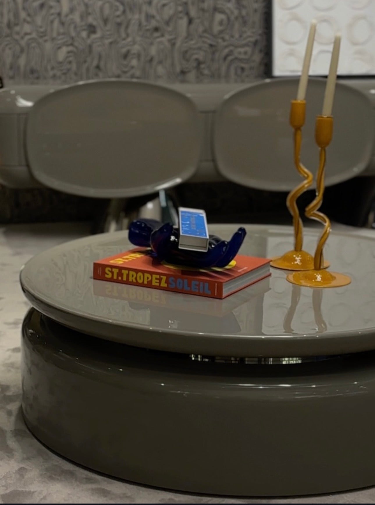 Lowlight modern lacquer furniture collection with sculptural orange sideboard, statement coffee tables, and contemporary dining design.