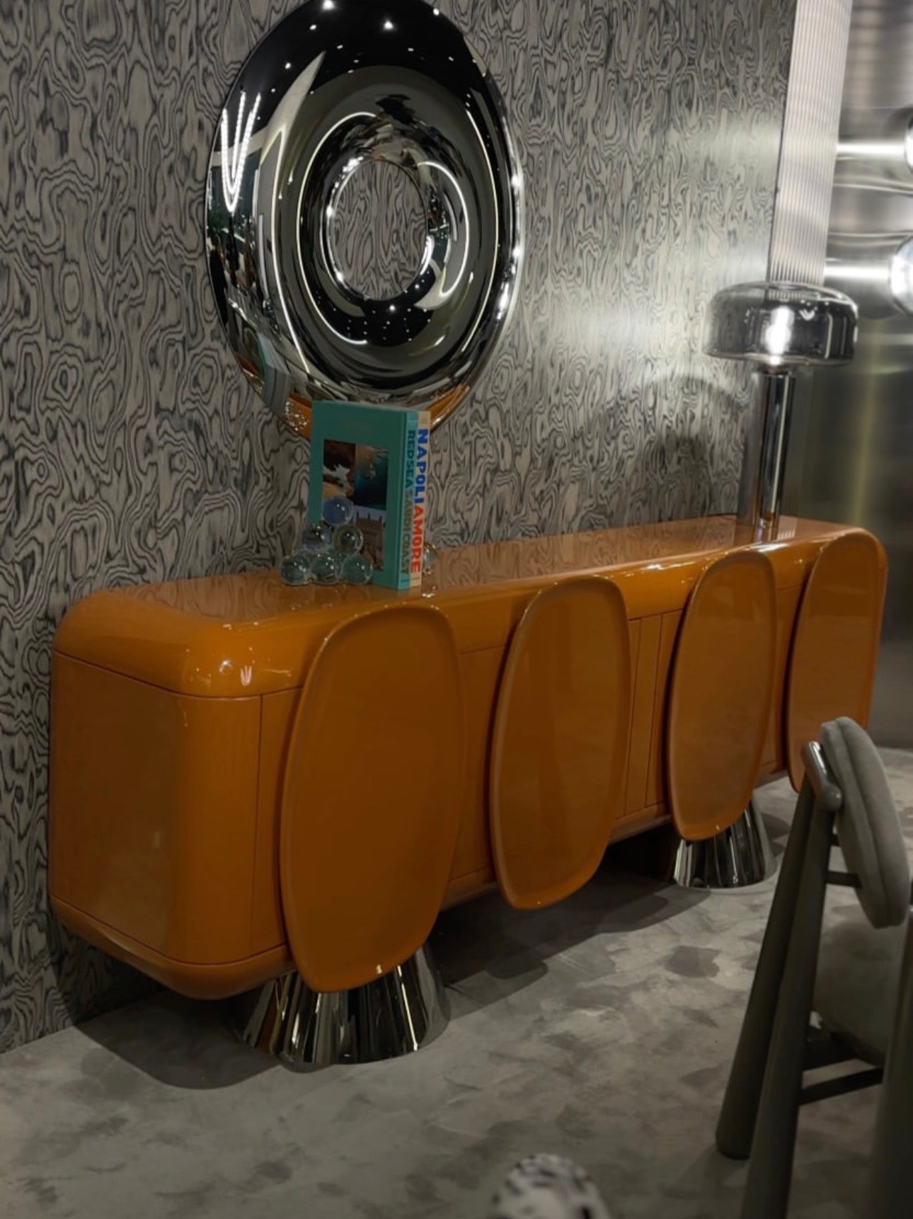 Lowlight modern lacquer furniture collection with sculptural orange sideboard, statement coffee tables, and contemporary dining design.