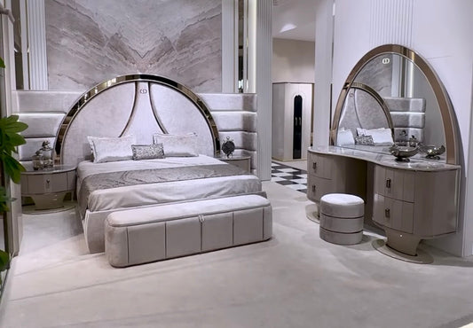 Crown luxury modern bedroom furniture collection with arched statement bed, marble dining table, mirrored wardrobe, and sculptural vanity.