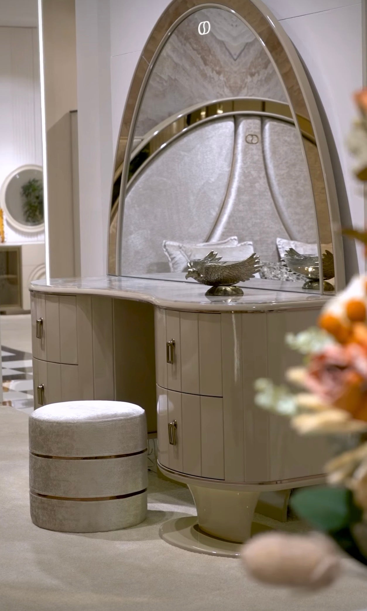 Crown luxury modern bedroom furniture collection with arched statement bed, marble dining table, mirrored wardrobe, and sculptural vanity.