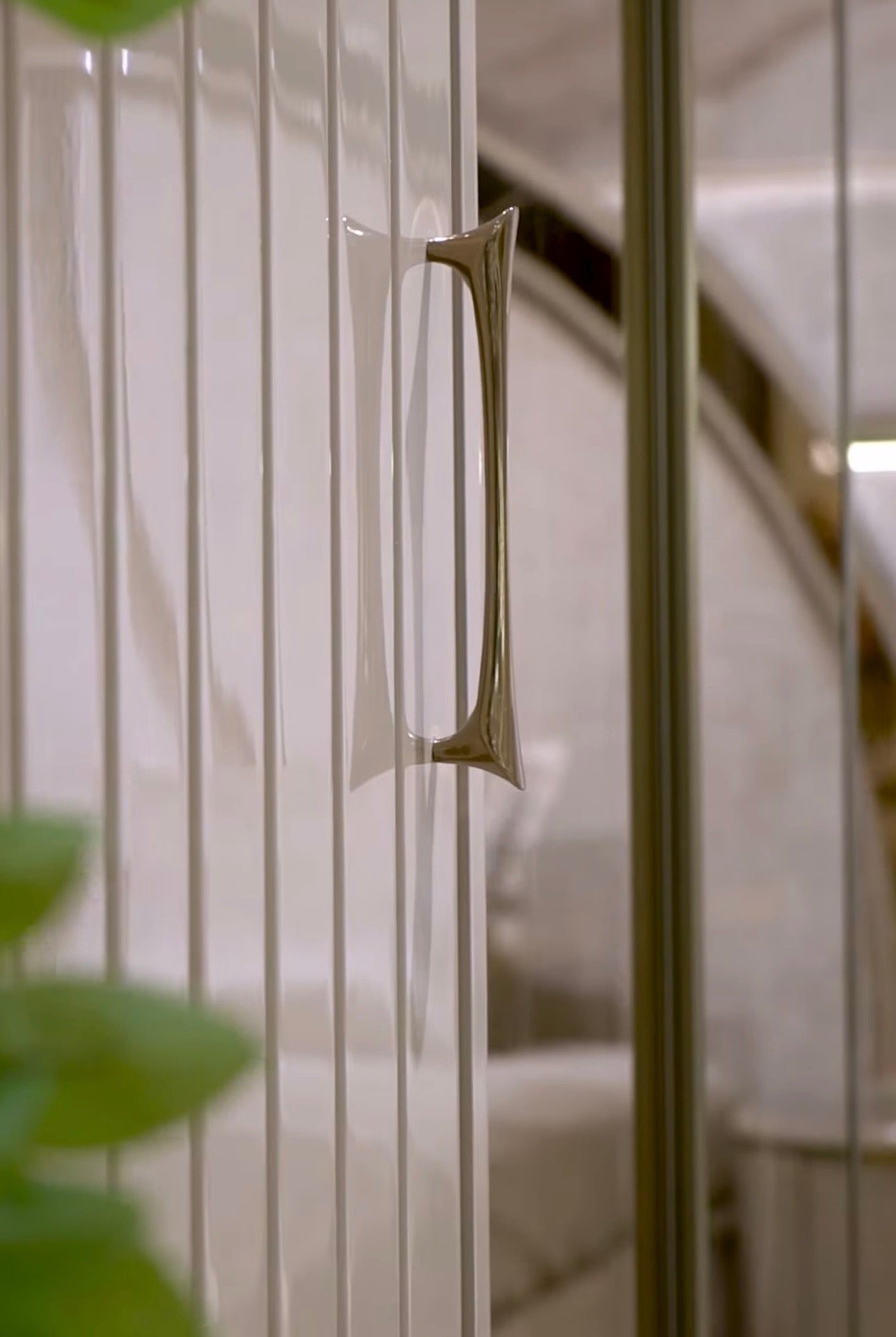 Crown luxury modern bedroom furniture collection with arched statement bed, marble dining table, mirrored wardrobe, and sculptural vanity.