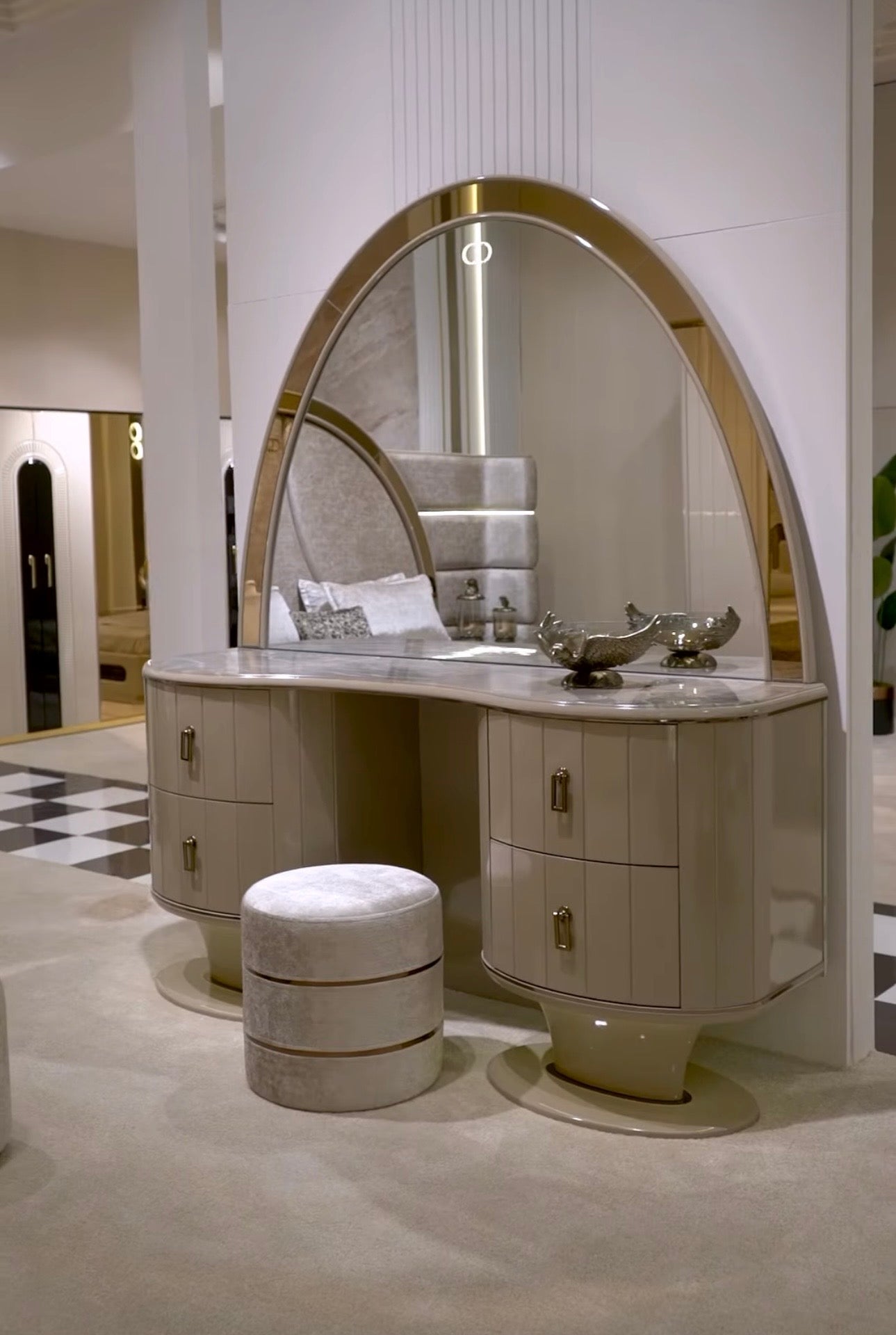 Crown luxury modern bedroom furniture collection with arched statement bed, marble dining table, mirrored wardrobe, and sculptural vanity.