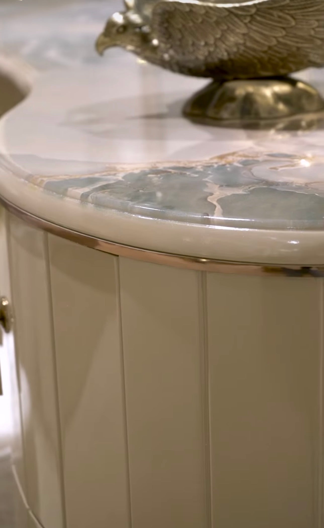 Crown luxury modern bedroom furniture collection with arched statement bed, marble dining table, mirrored wardrobe, and sculptural vanity.