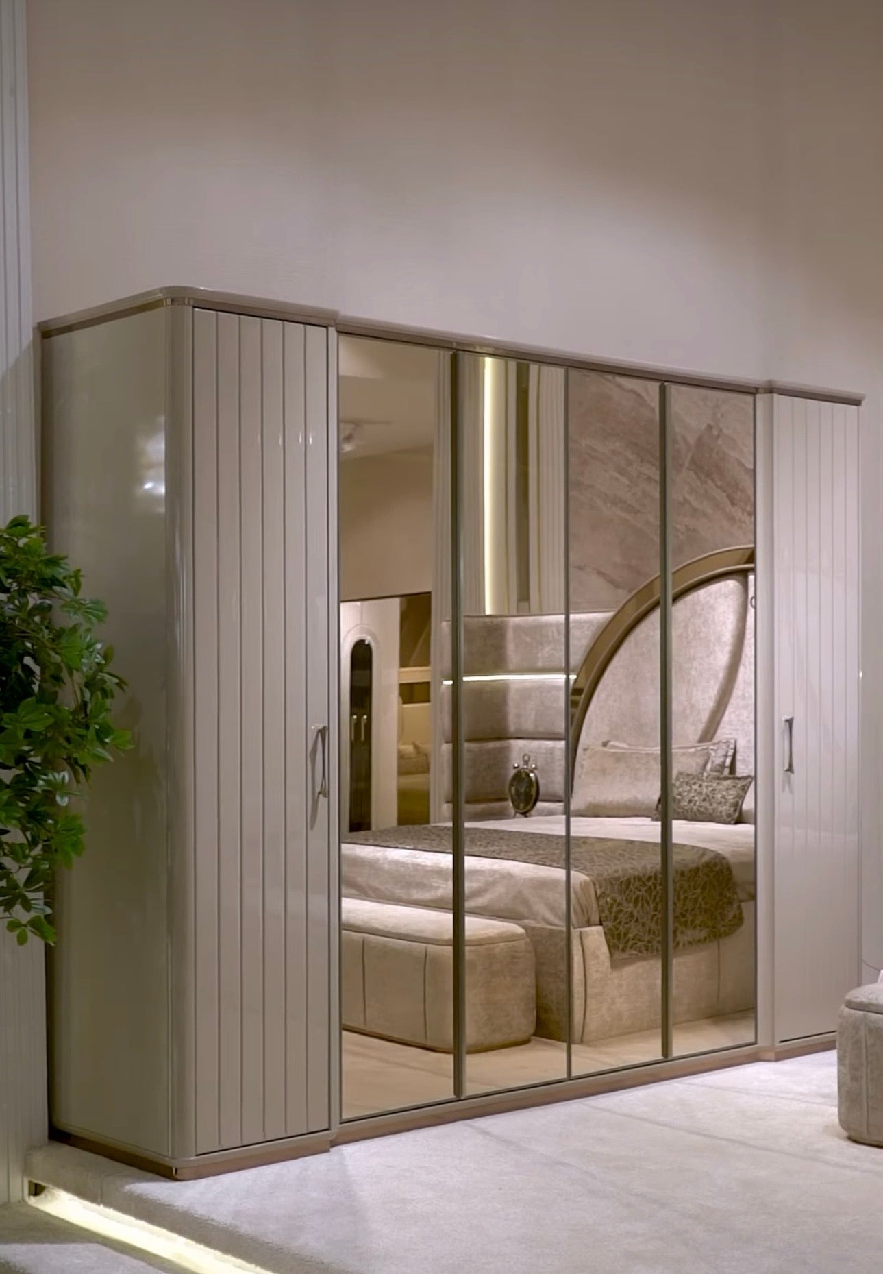 Crown luxury modern bedroom furniture collection with arched statement bed, marble dining table, mirrored wardrobe, and sculptural vanity.