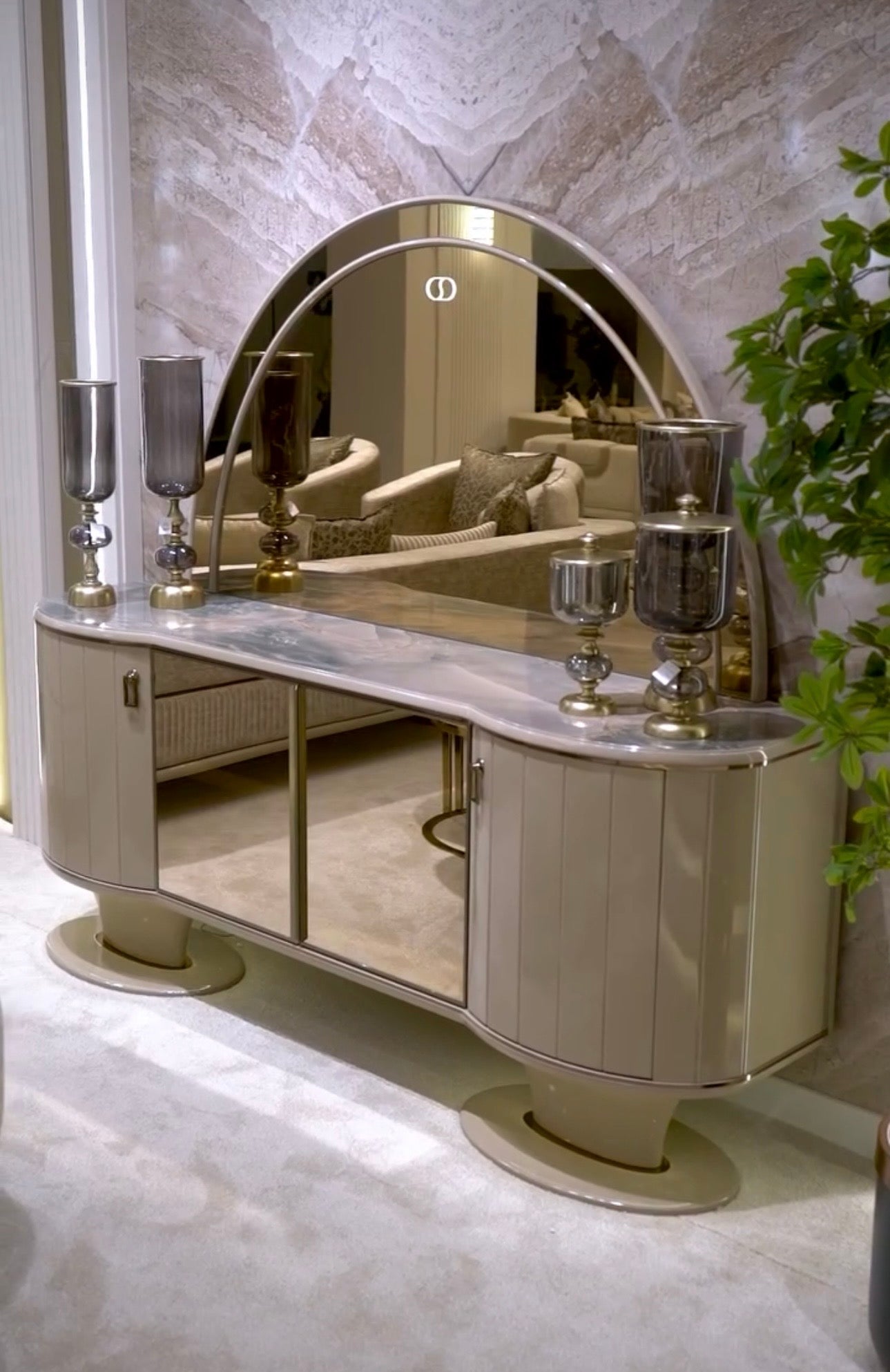 Crown luxury modern bedroom furniture collection with arched statement bed, marble dining table, mirrored wardrobe, and sculptural vanity.