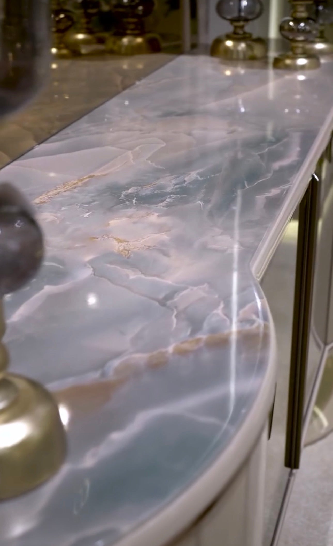 Crown luxury modern bedroom furniture collection with arched statement bed, marble dining table, mirrored wardrobe, and sculptural vanity.