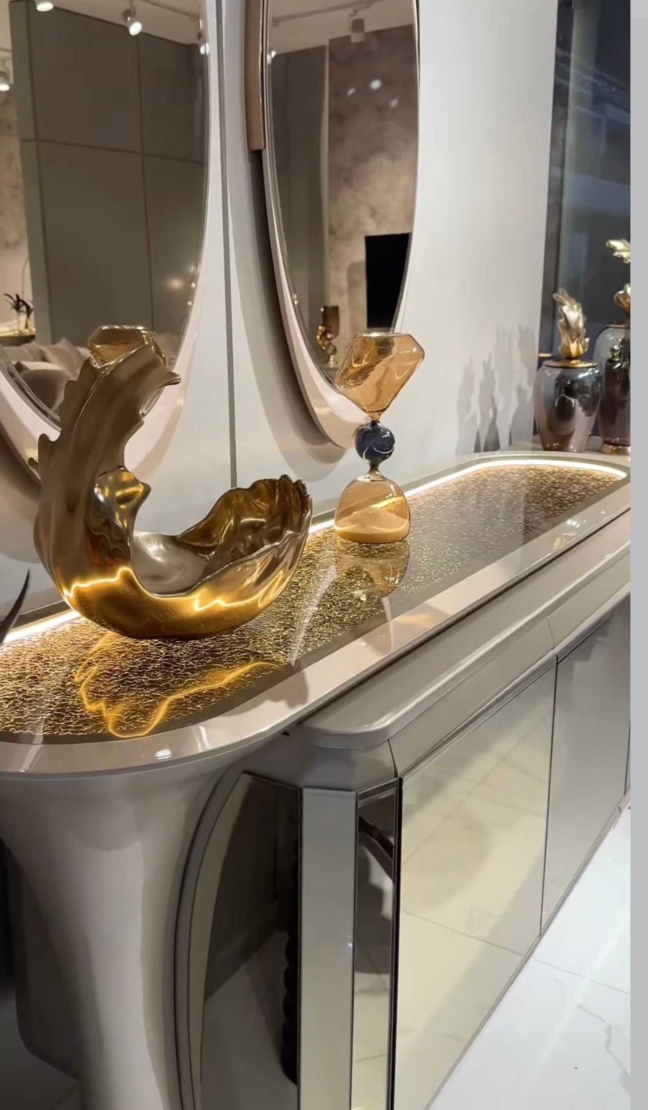 Heiroom luxury modern bedroom furniture collection with sculptural upholstered bed, mirrored console, and elegant vanity design.