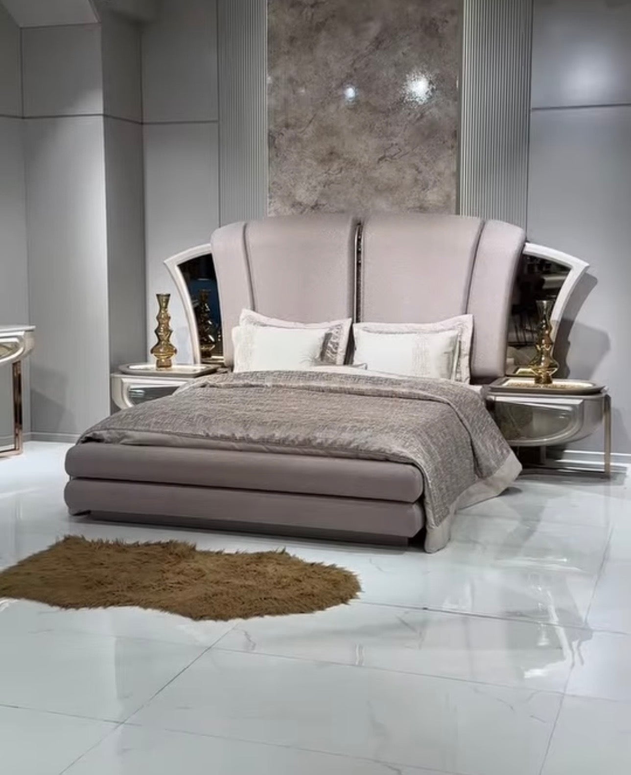 Heiroom luxury modern bedroom furniture collection with sculptural upholstered bed, mirrored console, and elegant vanity design.
