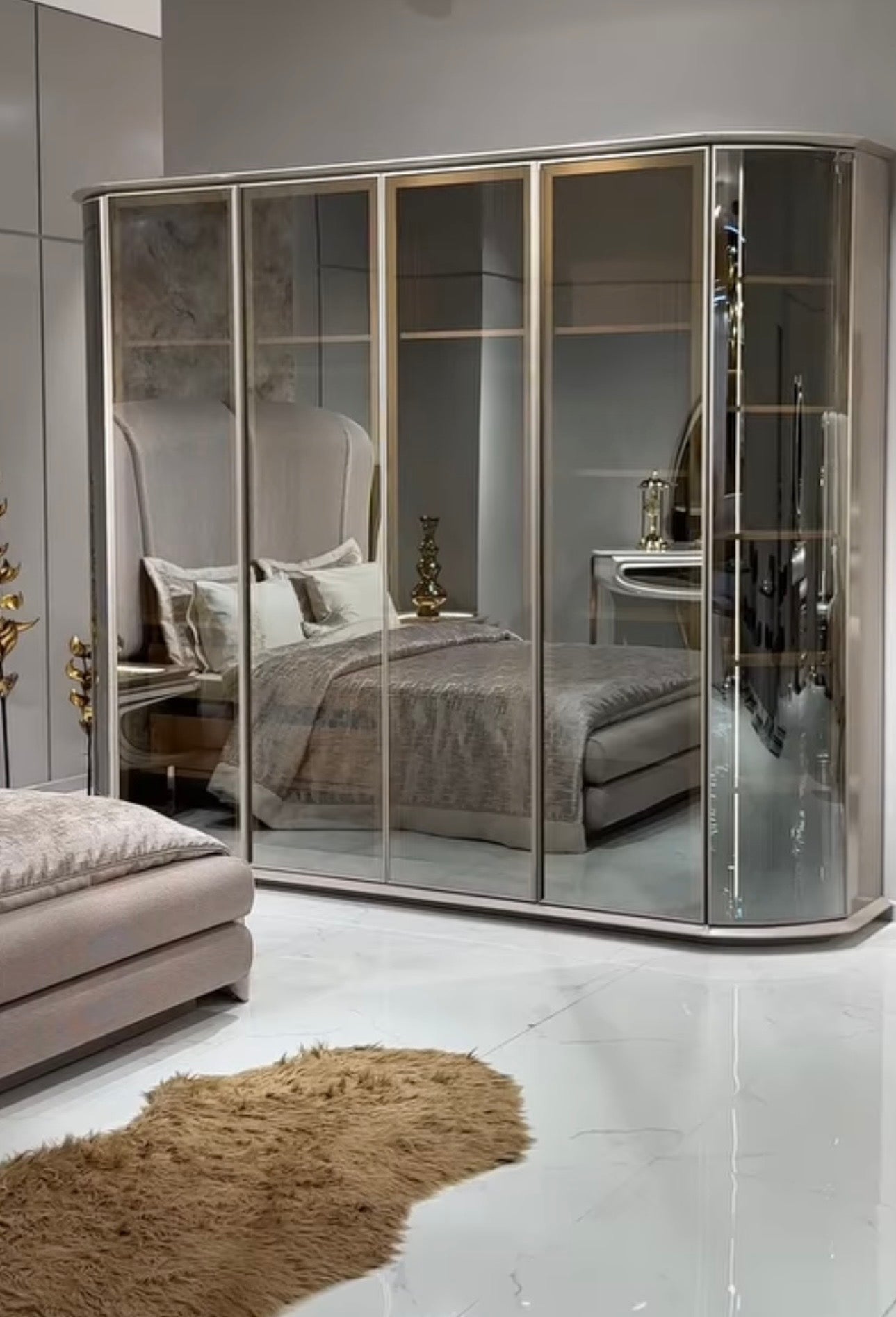 Heiroom luxury modern bedroom furniture collection with sculptural upholstered bed, mirrored console, and elegant vanity design.