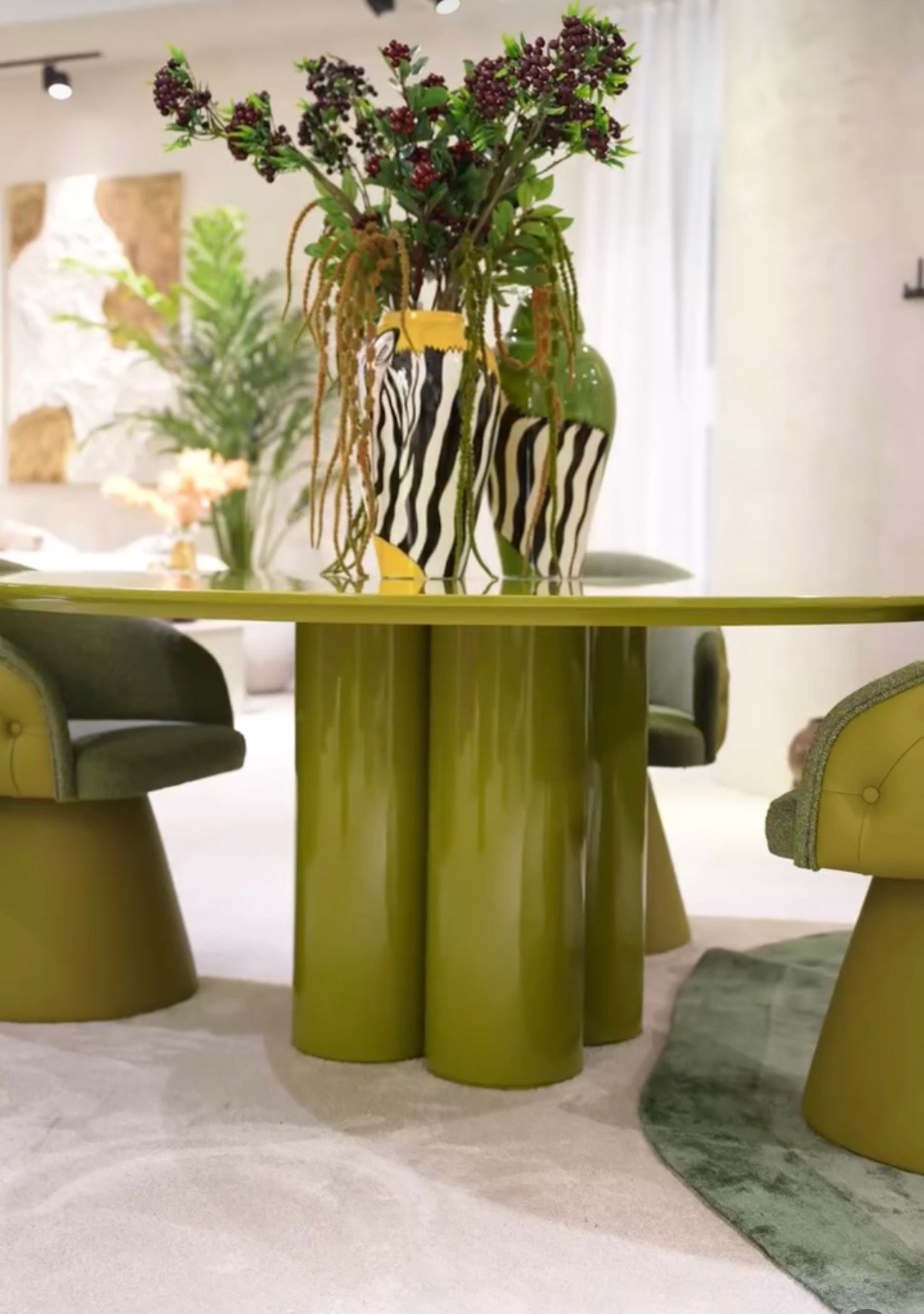 Honey modern luxury dining furniture collection with sculptural green dining table and tufted pedestal dining chairs.