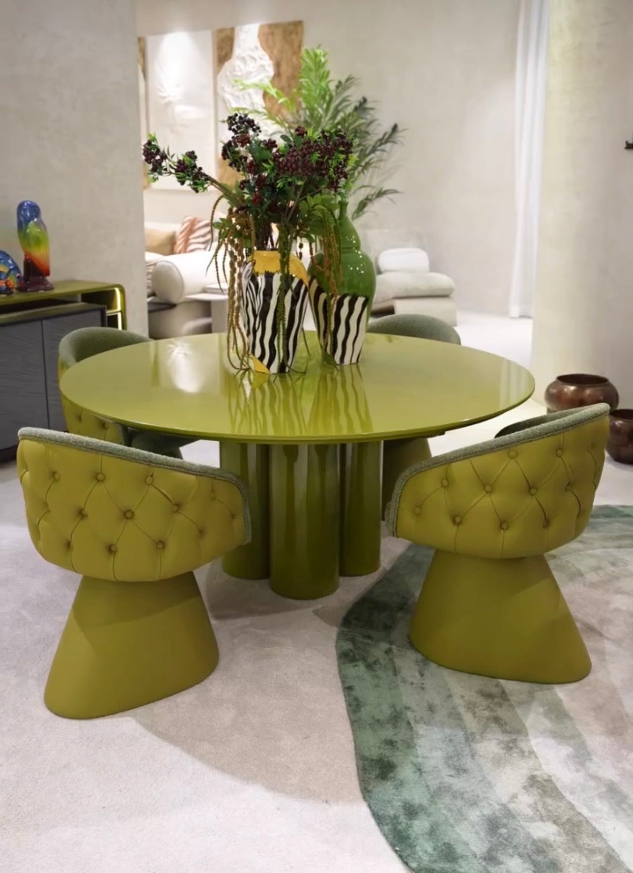 Honey modern luxury dining furniture collection with sculptural green dining table and tufted pedestal dining chairs.