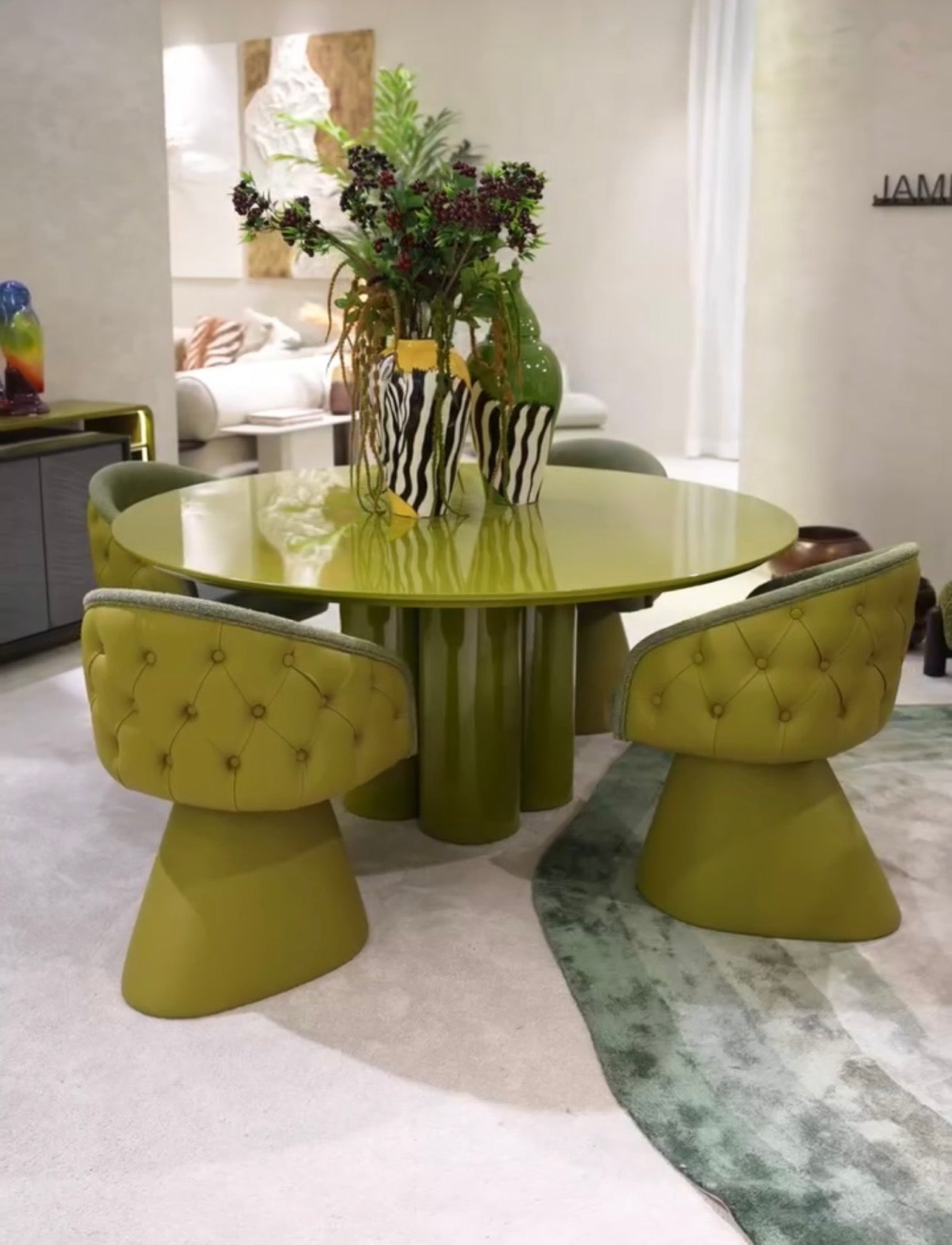 Honey modern luxury dining furniture collection with sculptural green dining table and tufted pedestal dining chairs.