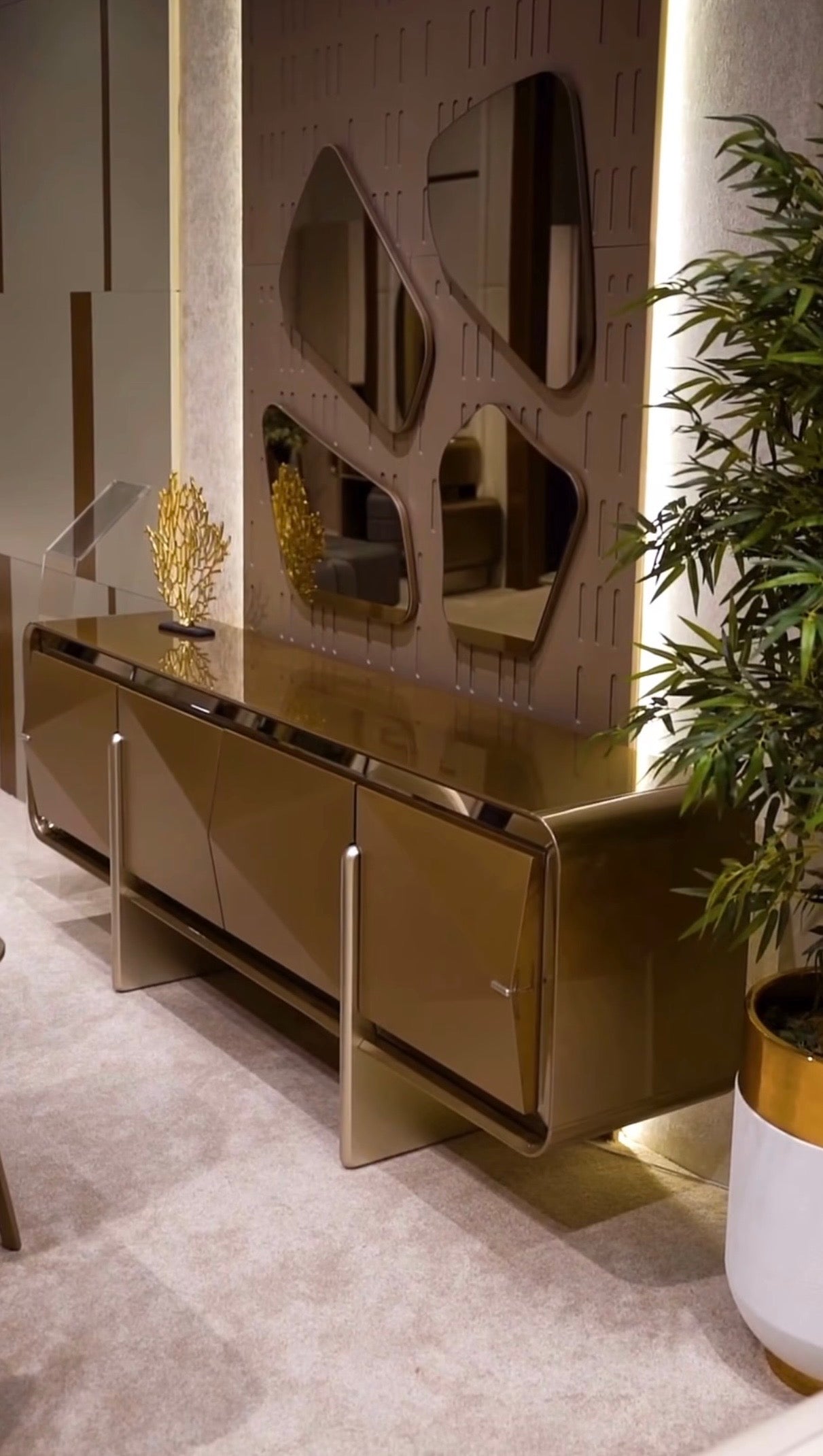 Aurelius luxury furniture collection with sculptural console, modern mirror, and metallic accent cabinetry.