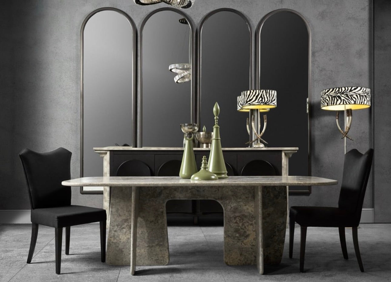 Panthera luxury furniture collection featuring statement sofa, sculptural coffee table, pedestal table, and modern shelving in dark finishes.