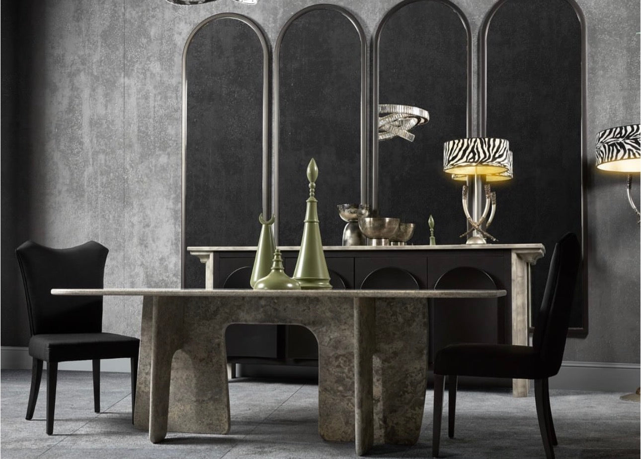 Panthera luxury furniture collection featuring statement sofa, sculptural coffee table, pedestal table, and modern shelving in dark finishes.