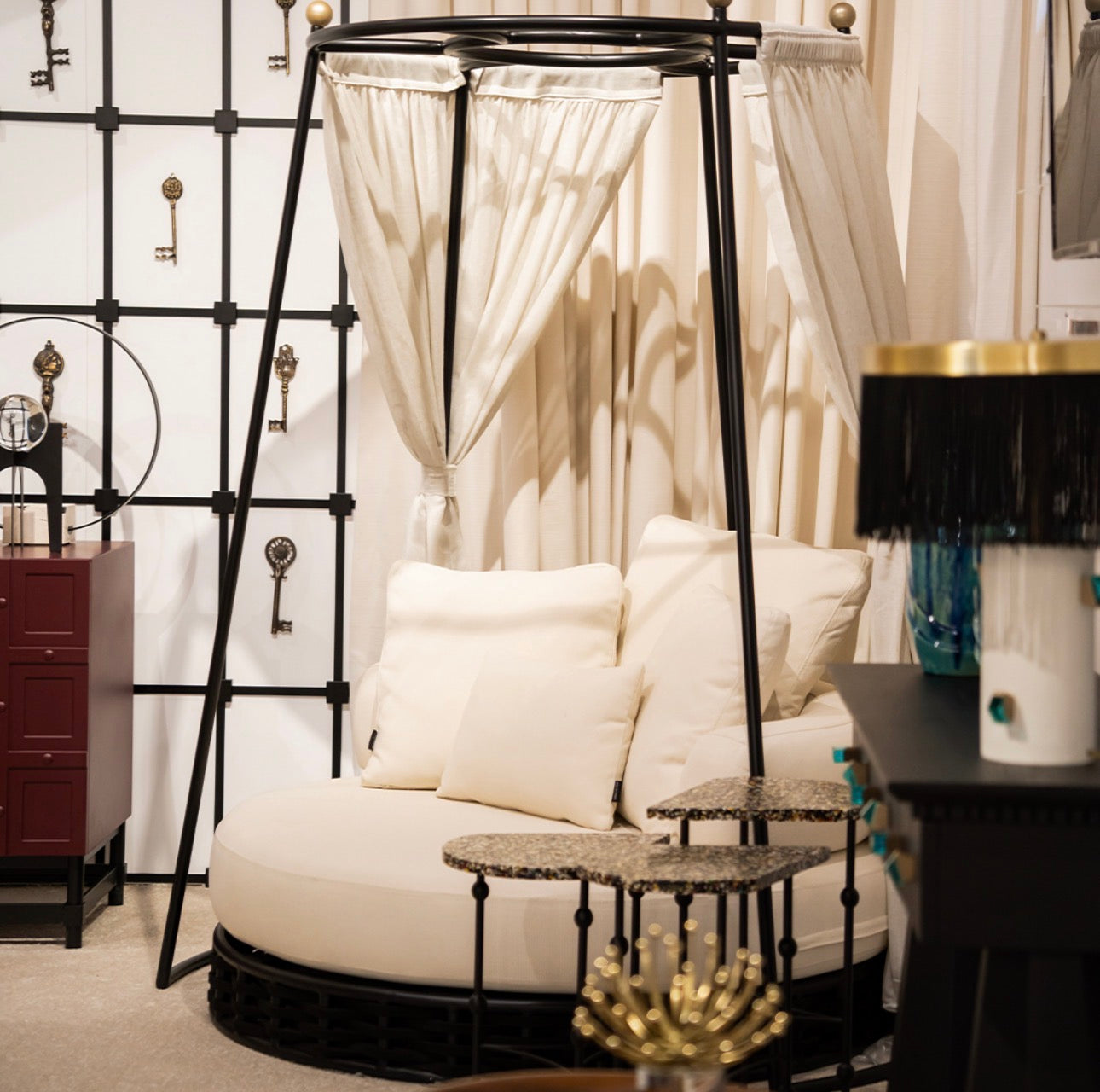 Sanctuarie luxury canopy lounge chair with draped fabric and deep cushioned seating