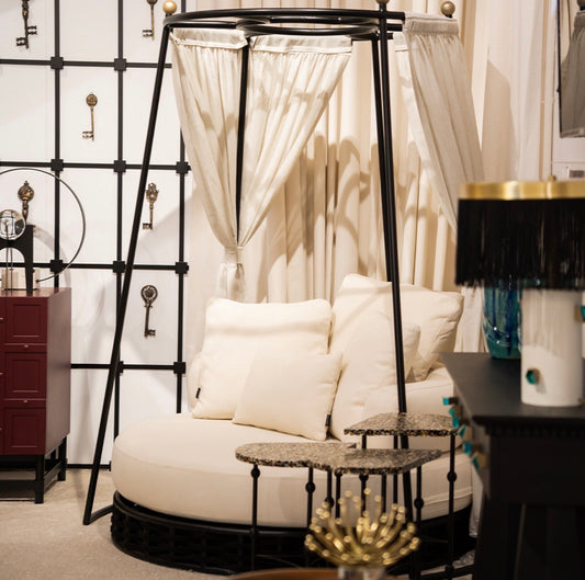 Sanctuarie luxury canopy lounge chair with draped fabric and deep cushioned seating