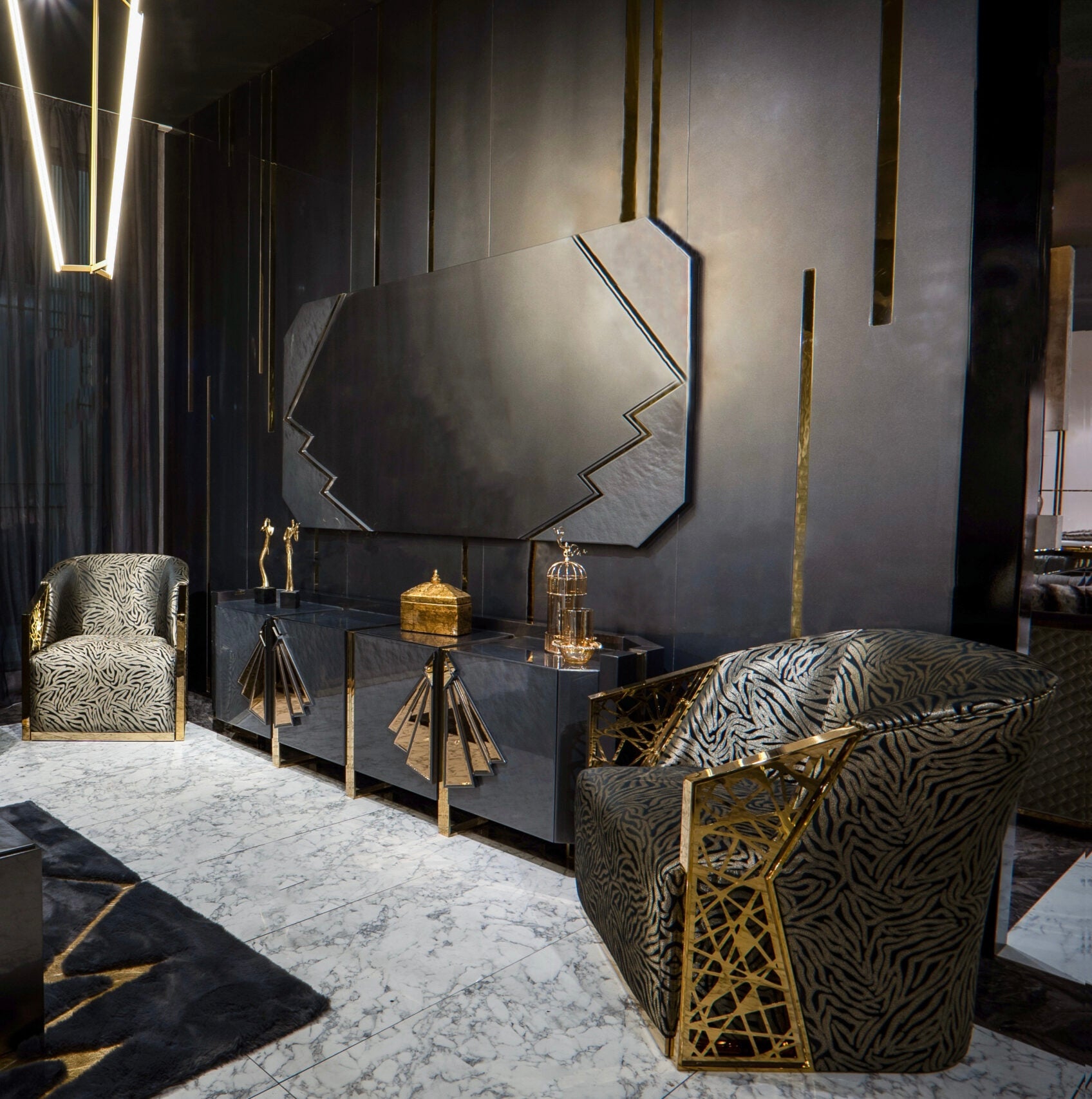 Frost luxury furniture collection featuring geometric wall mirror, dark lacquer sideboard with gold accents, and patterned armchairs with sculptural brass frames.