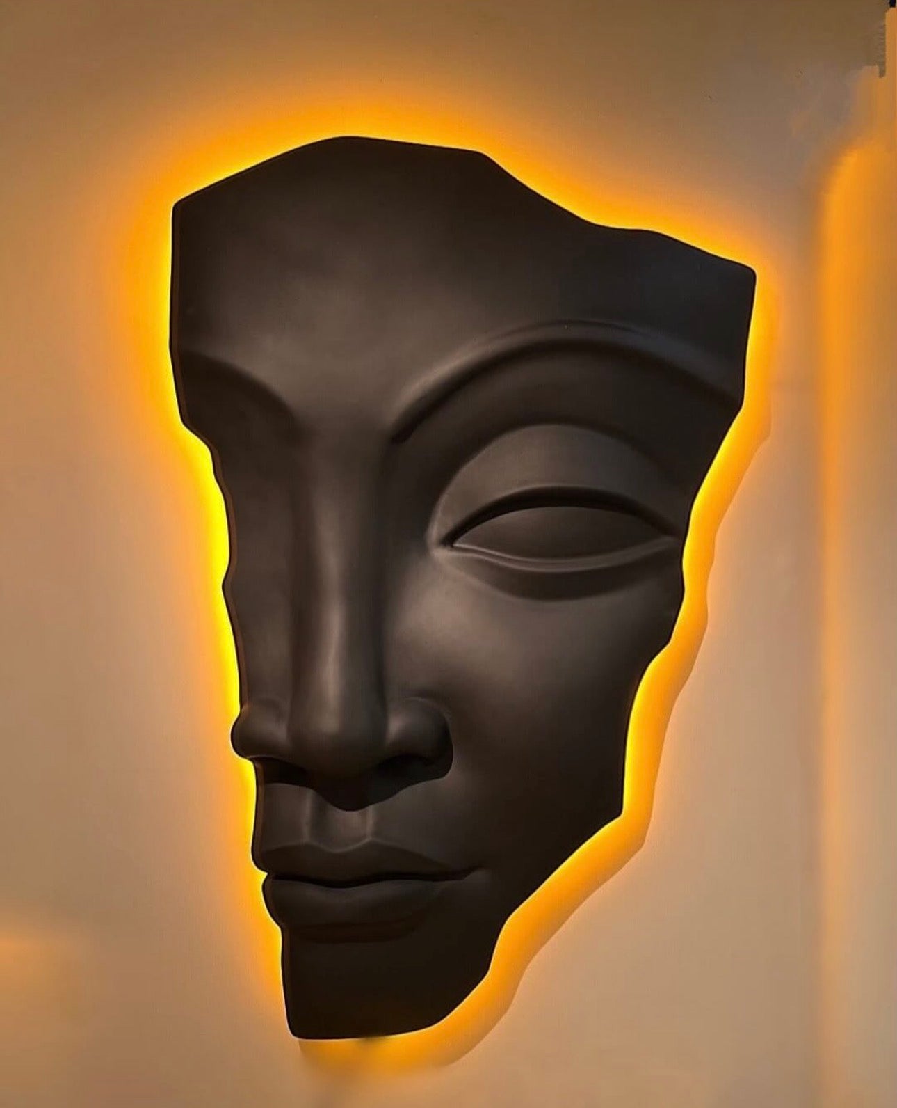 Roman sculptural wall art with illuminated backlit design creating a dramatic modern interior feature.