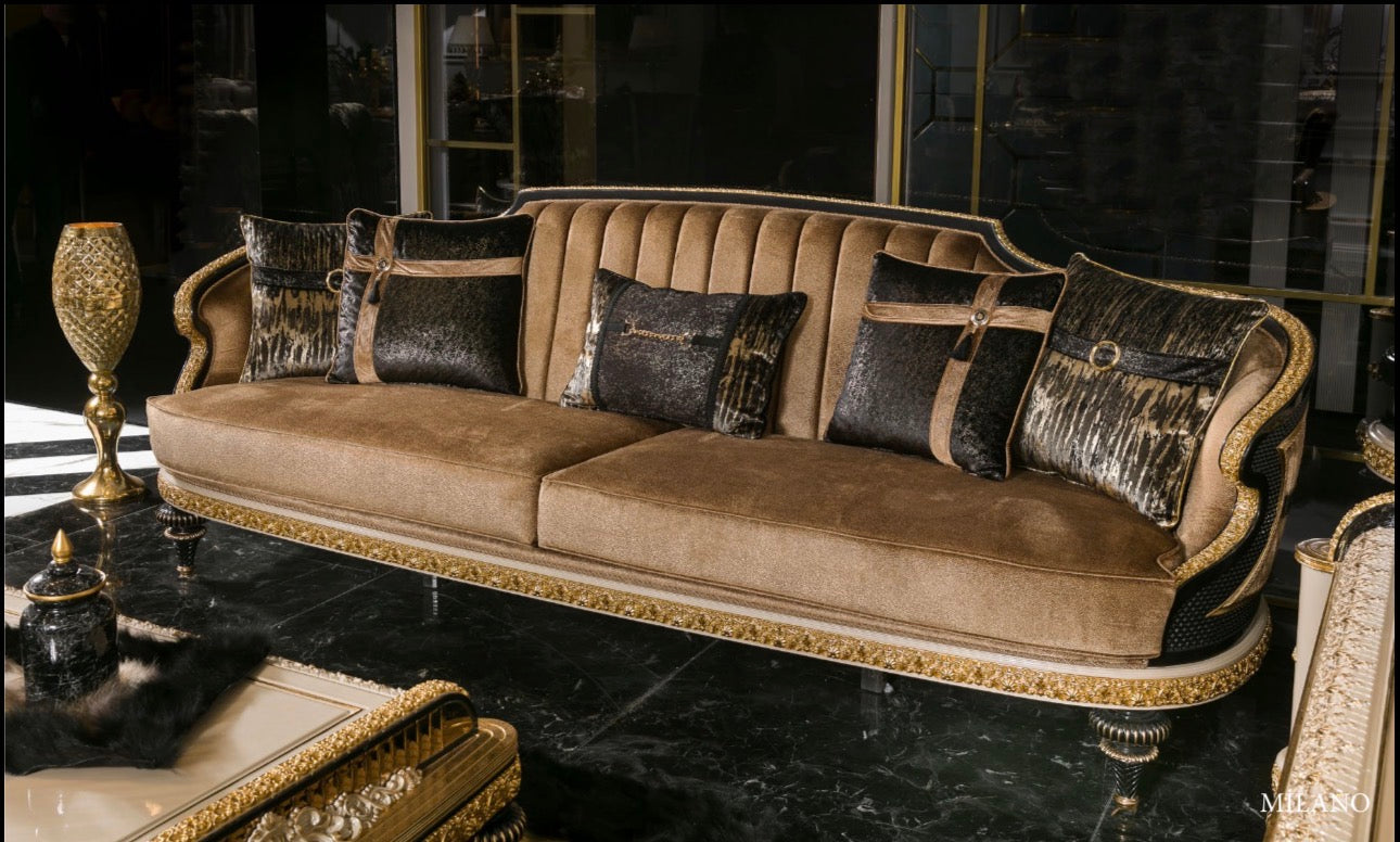 Regalia luxury furniture collection featuring ornate gold living room seating and classic dining set with intricate detailing and black marble flooring.