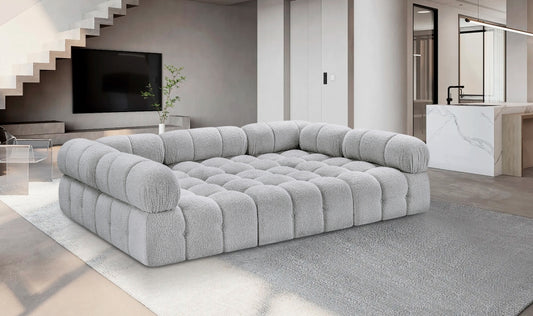 Fancci Stonecrest Atelier deep tufted modular sectional sofa with oversized design in a modern luxury living space.