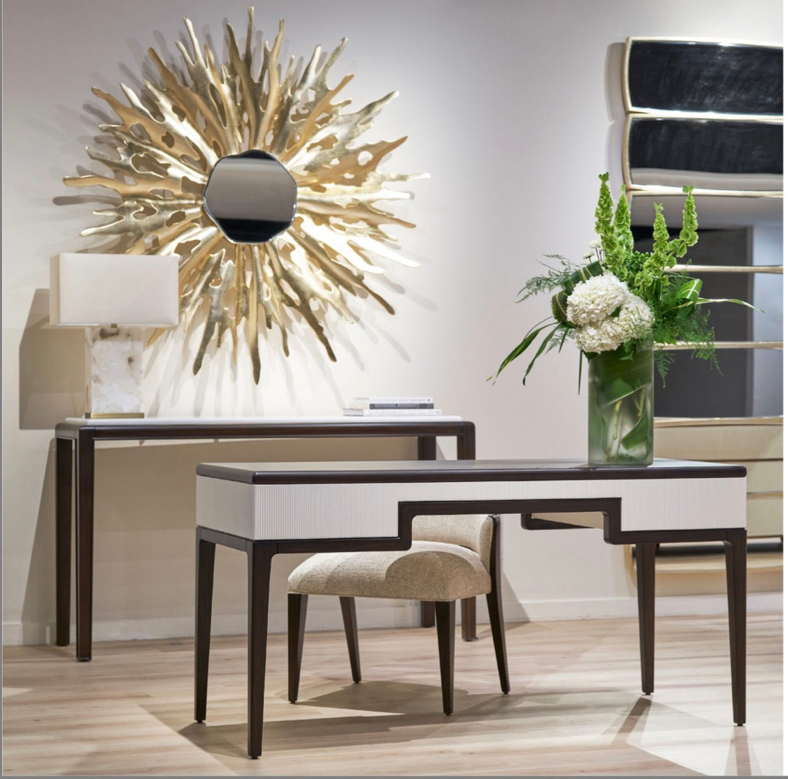 Fancci Orvelle sculptural wall mirror with organic asymmetrical shape styled above a luxury console in a modern interior.