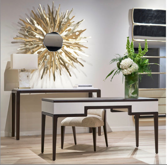 Fancci Orvelle sculptural wall mirror with organic asymmetrical shape styled above a luxury console in a modern interior.