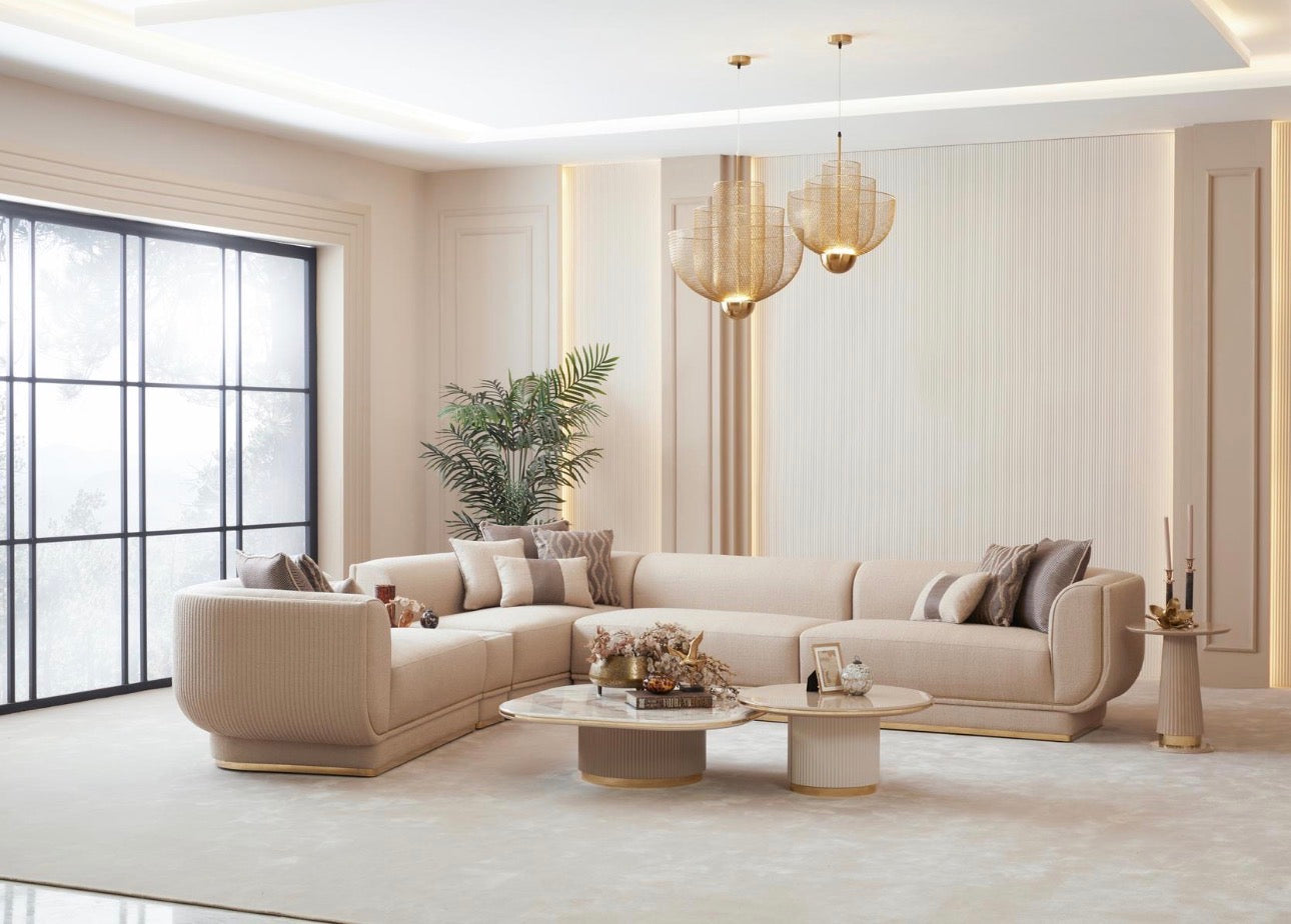 Fancci Valorex luxury living room and dining collection with curved sofas, gold accents, and soft neutral tones in a modern interior.