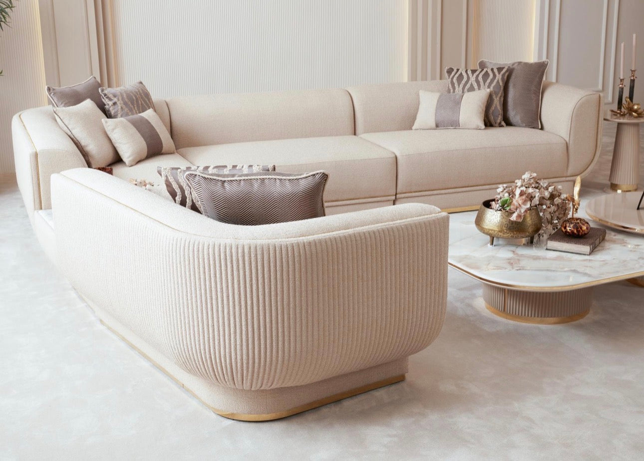 Fancci Valorex luxury living room and dining collection with curved sofas, gold accents, and soft neutral tones in a modern interior.