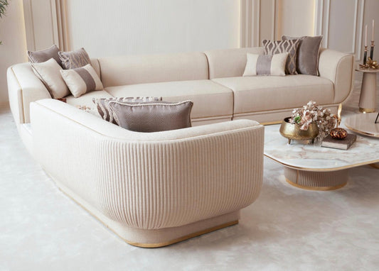 Fancci Valorex luxury living room and dining collection with curved sofas, gold accents, and soft neutral tones in a modern interior.