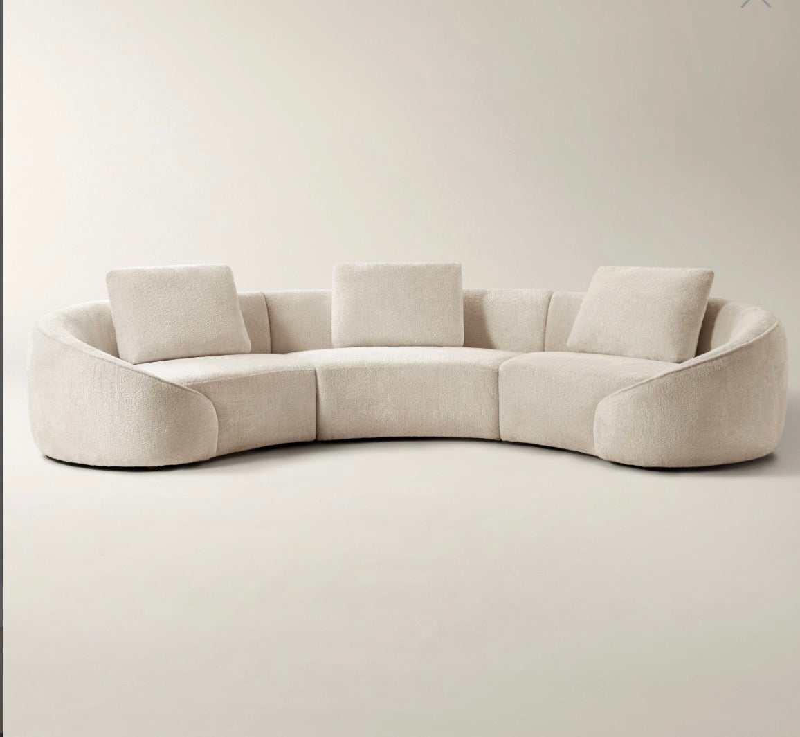 Twin Arc curved sectional sofa in neutral grey and cream tones with soft modern luxury styling.
