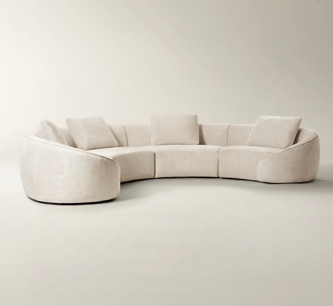 Twin Arc curved sectional sofa in neutral grey and cream tones with soft modern luxury styling.
