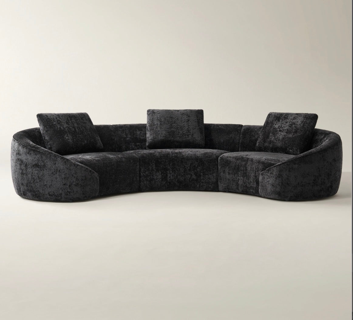 Twin Arc curved sectional sofa in neutral grey and cream tones with soft modern luxury styling.