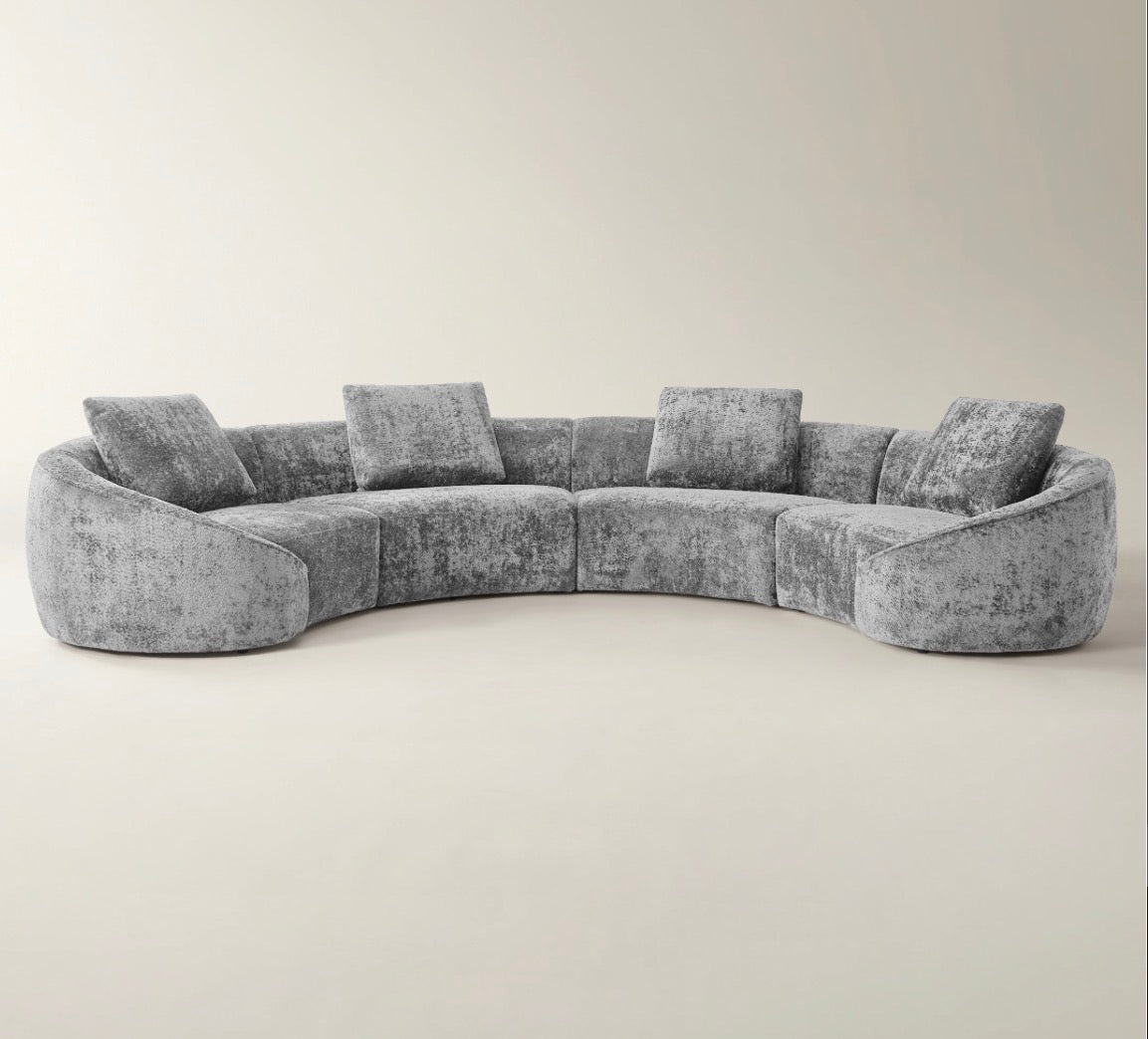 Twin Arc curved sectional sofa in neutral grey and cream tones with soft modern luxury styling.