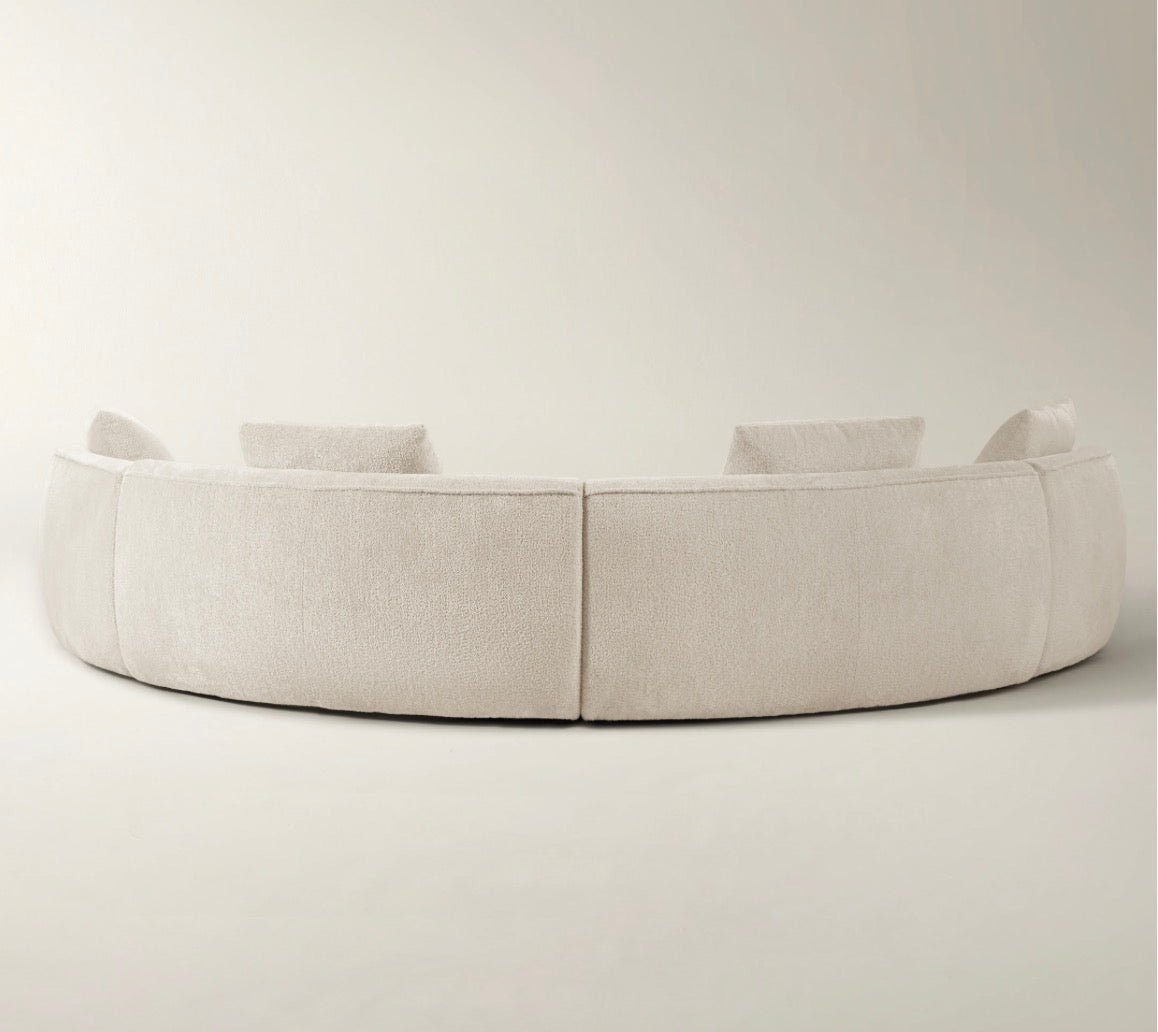 Twin Arc curved sectional sofa in neutral grey and cream tones with soft modern luxury styling.